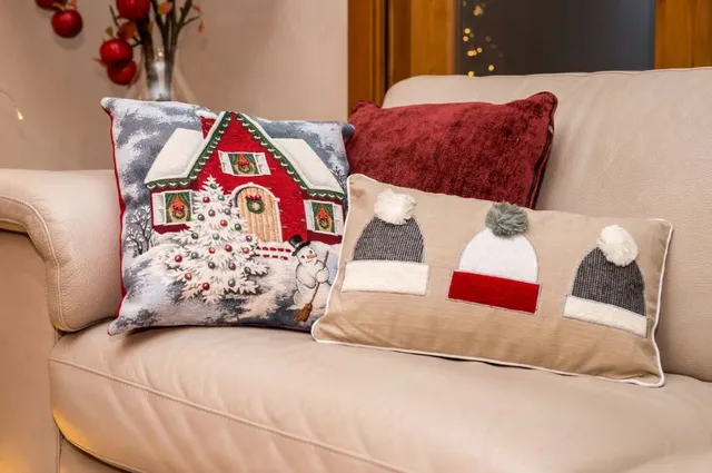 Sul divano, i cuscini autunnali cedono il posto a quelli in fantasia natalizia